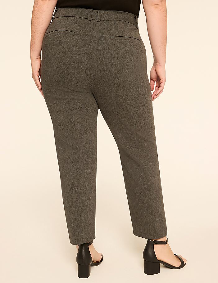 A person wearing patterned gray pants and black heels stands against a plain, light-colored background.