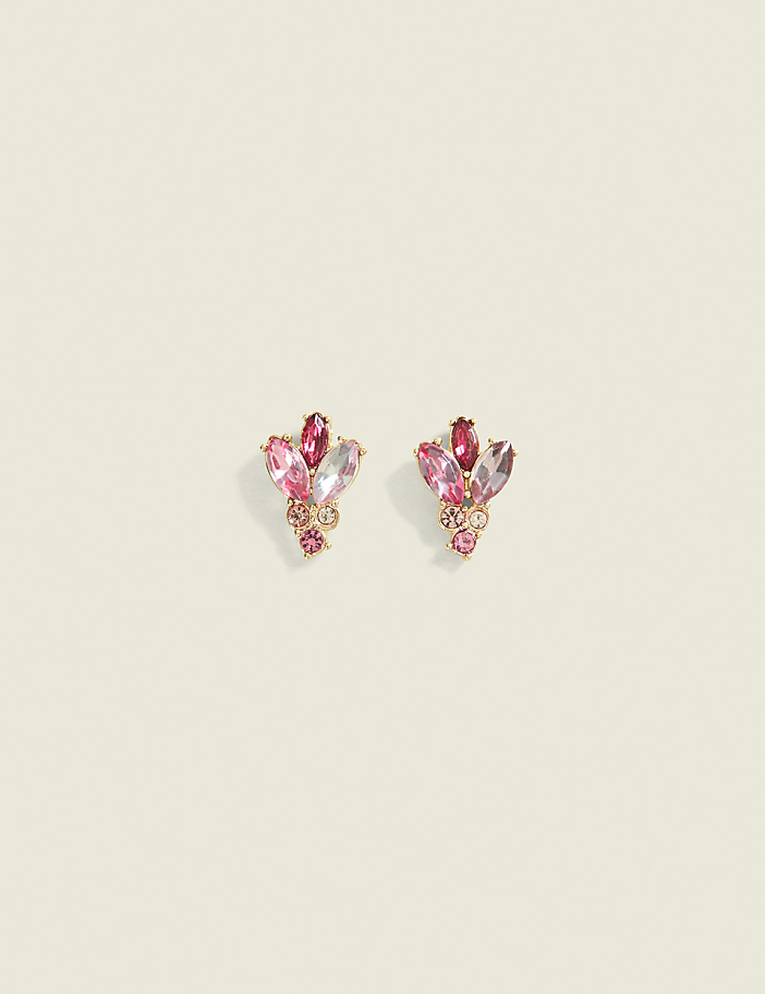 A pair of delicate pink gemstone cluster earrings rests on a pale, textured background.