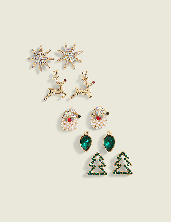 A collection of festive Christmas-themed earrings, including snowflakes, reindeer, Santa Claus, ornaments, and Christmas trees, are arranged on a pale green background.