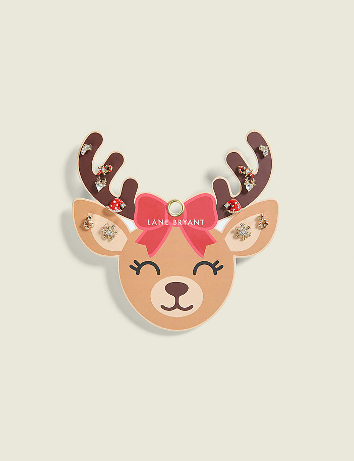 A festive reindeer earring display with a pink bow and jeweled antlers is set against a pale, textured background.