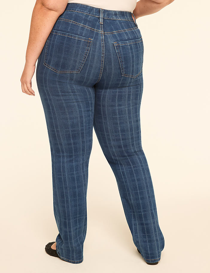 A person wearing plaid denim jeans stands against a plain, light-colored background.