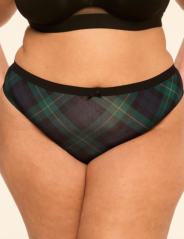 A person's lower torso is shown, with a close-up of plaid underwear in the foreground and a plain background.