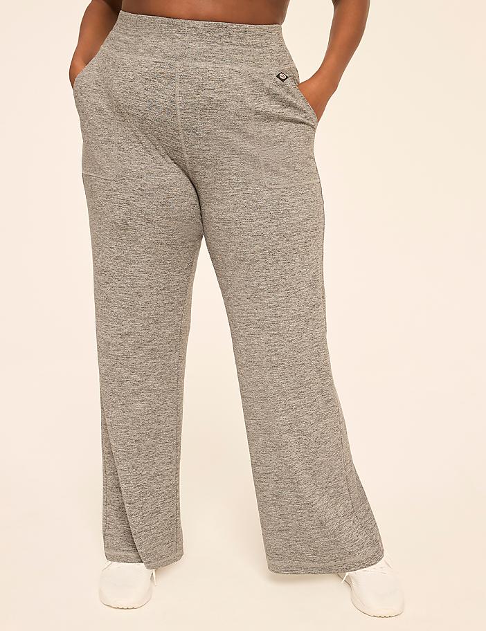 A person stands in heather gray sweatpants and white sneakers against a plain, light-colored background.