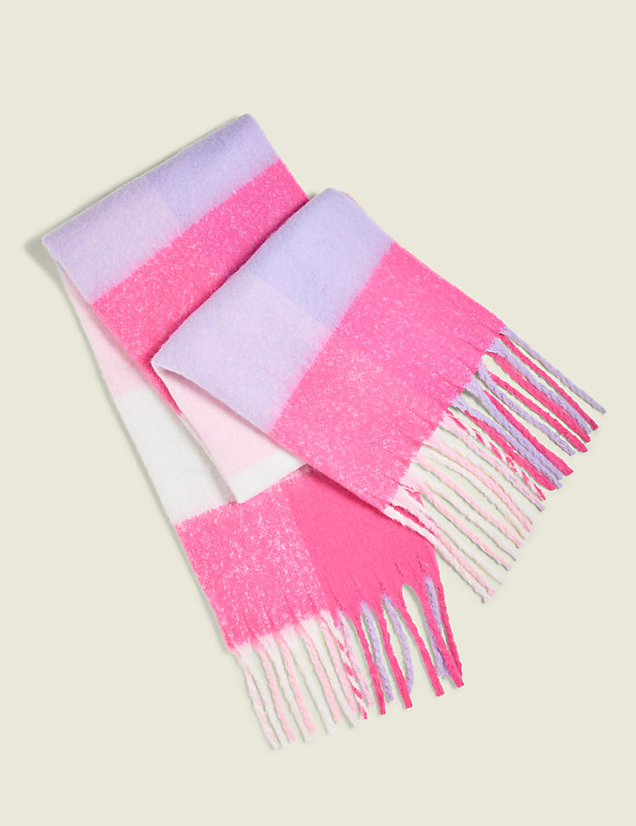 A fluffy, striped scarf with pink, purple, and white sections and fringed ends lies on a plain, light-colored background.