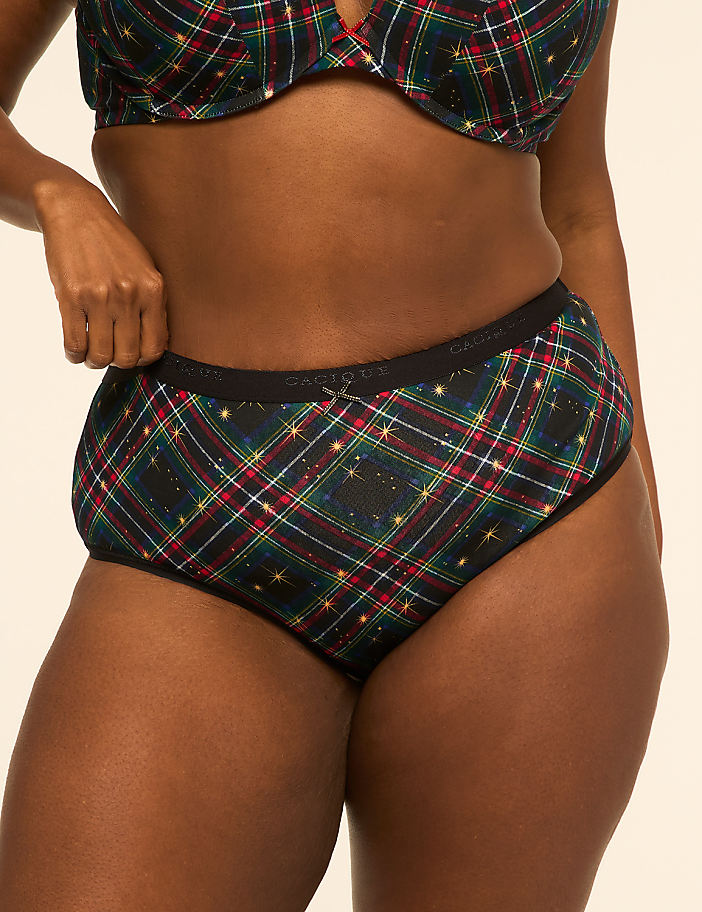 A person wearing high-waisted plaid underwear with a matching bra is shown against a plain, light-colored background.