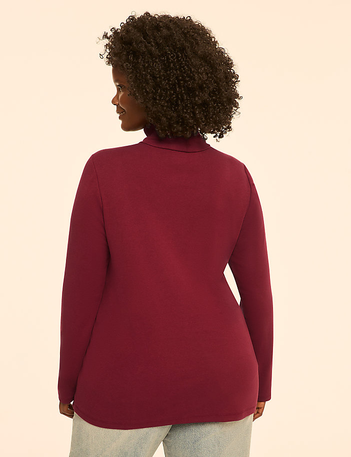 A woman in a red turtleneck is shown from the back against a plain, light-colored background.