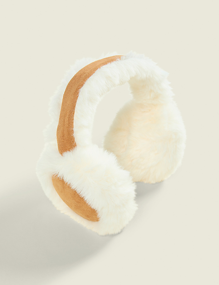 White and tan faux-fur earmuffs sit against a plain, light beige background.