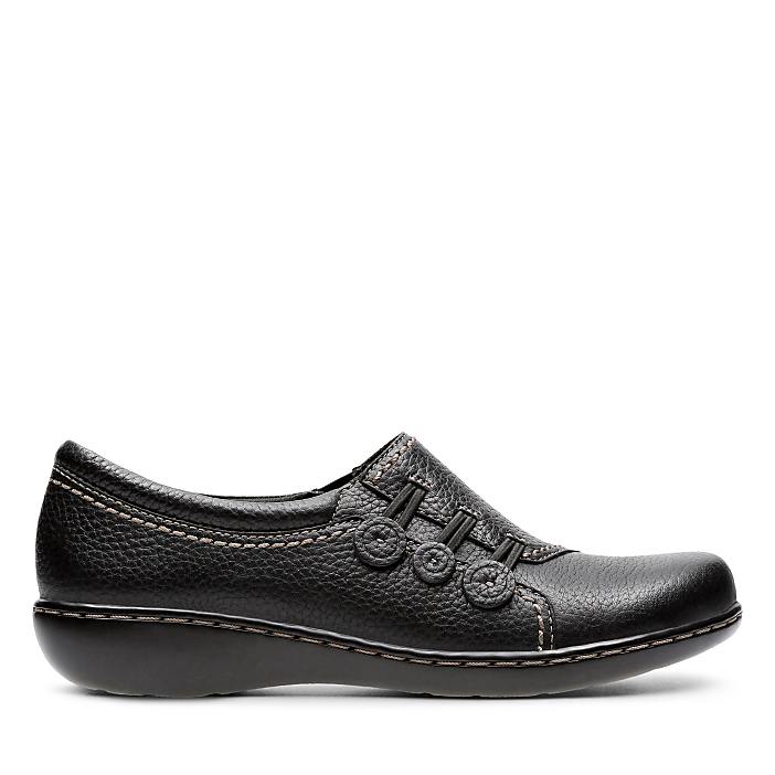 A single black leather loafer sits in the foreground against a plain white background.