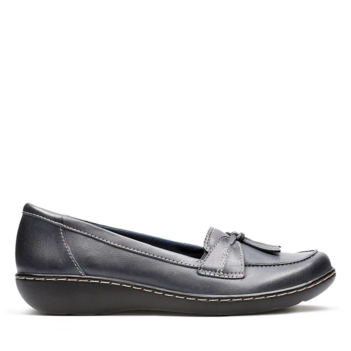 A single navy blue loafer with white stitching sits against a plain white background.