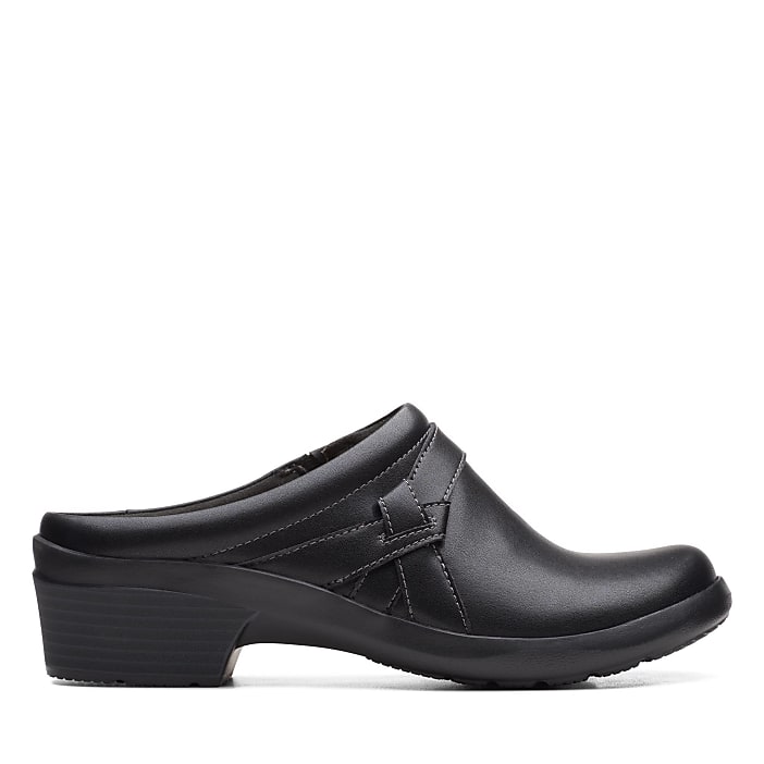 A single black leather clog sits in the foreground against a plain white background.