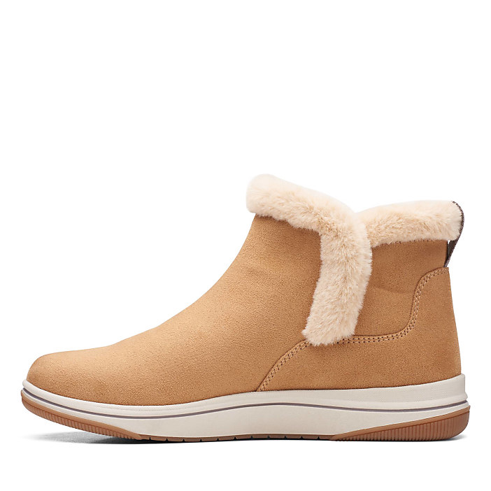 A tan suede ankle boot with a faux-fur lining is centered against a plain white background.