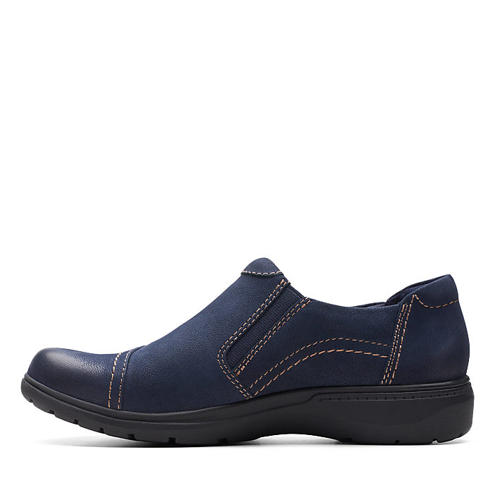 A single navy blue slip-on shoe with contrast stitching sits against a plain white background.