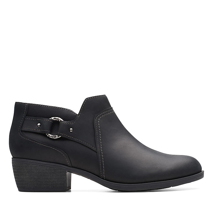 A black leather ankle boot with a decorative buckle sits against a plain white background.