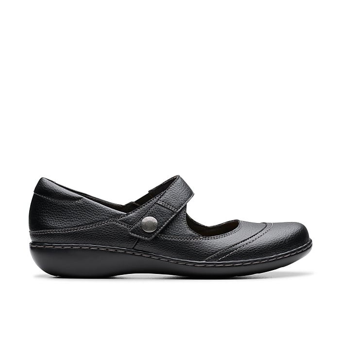 A single black leather shoe with a strap sits in the foreground against a plain white background.