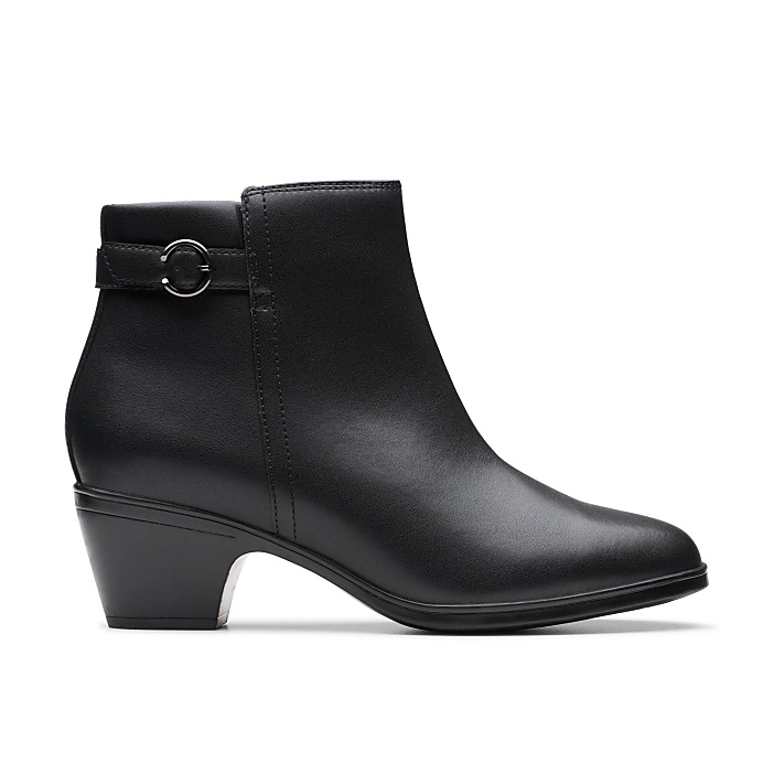 A black sock boot with a pointed toe and kitten heel stands against a plain white background.
