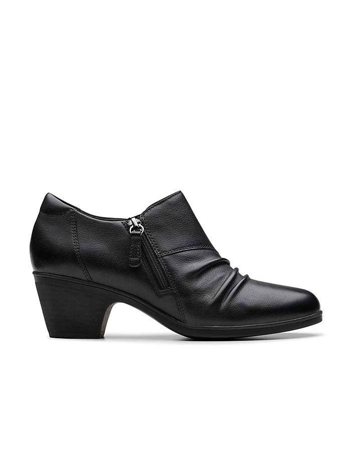 A black leather heeled shoe with a side zipper sits against a plain white background.