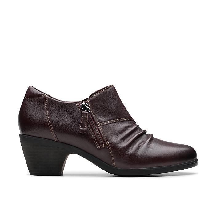A single dark brown leather ankle boot with a zipper stands against a plain white background.