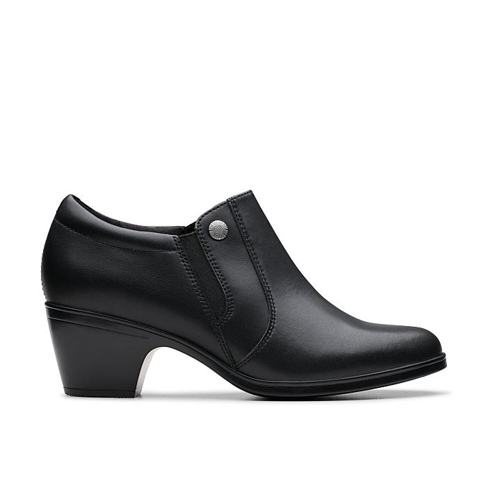 A single black leather low-heeled shoe sits centered against a plain white background.
