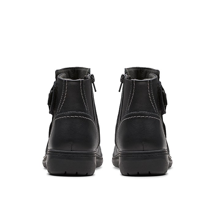 A pair of black leather boots are positioned side-by-side against a plain white background.