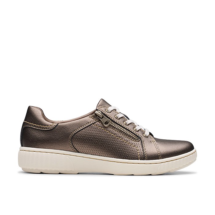 A metallic bronze sneaker with white laces and a white sole sits against a plain white background.