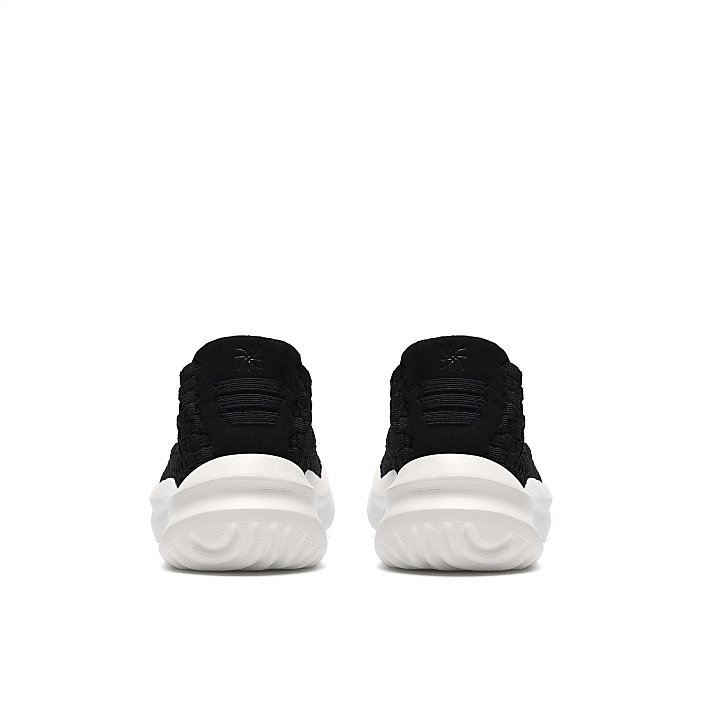A pair of black sneakers with white soles are positioned side-by-side against a plain white background.