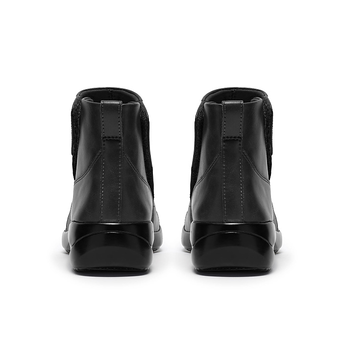 A pair of black leather Chelsea boots are positioned side-by-side against a plain white background.