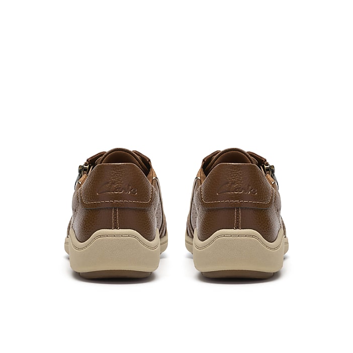 Two brown leather shoes are positioned side-by-side against a plain white background.