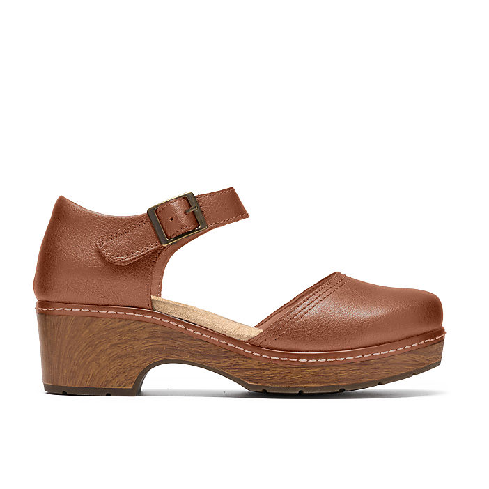 A brown leather strap shoe with a wooden sole sits against a plain white background.