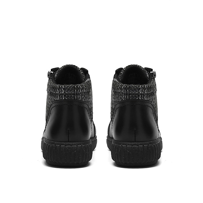 A pair of black and grey textured high-top sneakers are positioned centrally against a plain white background.