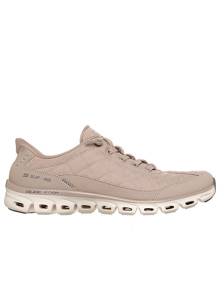 A single beige quilted sneaker sits in the foreground against a plain white background.