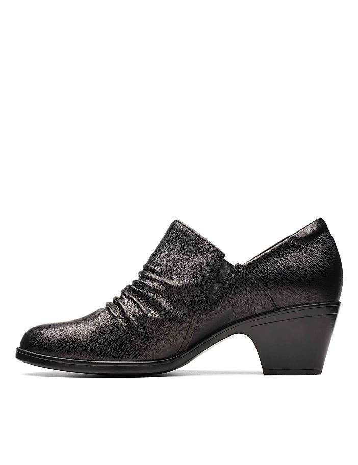 A black leather heeled shoe with a ruched front sits against a plain white background.