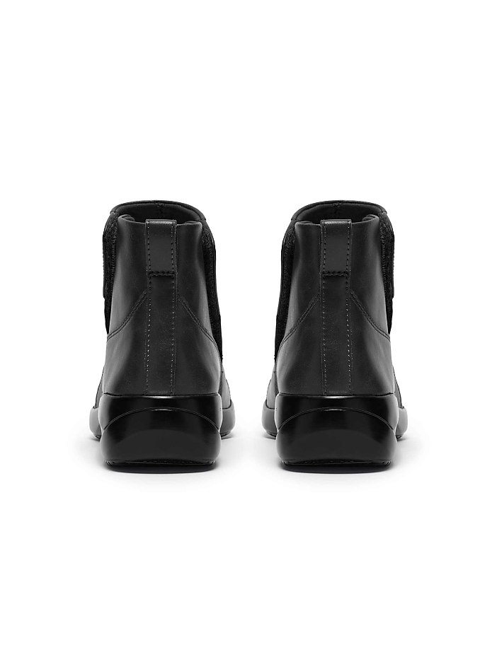 A pair of black leather Chelsea boots are positioned side-by-side against a plain white background.