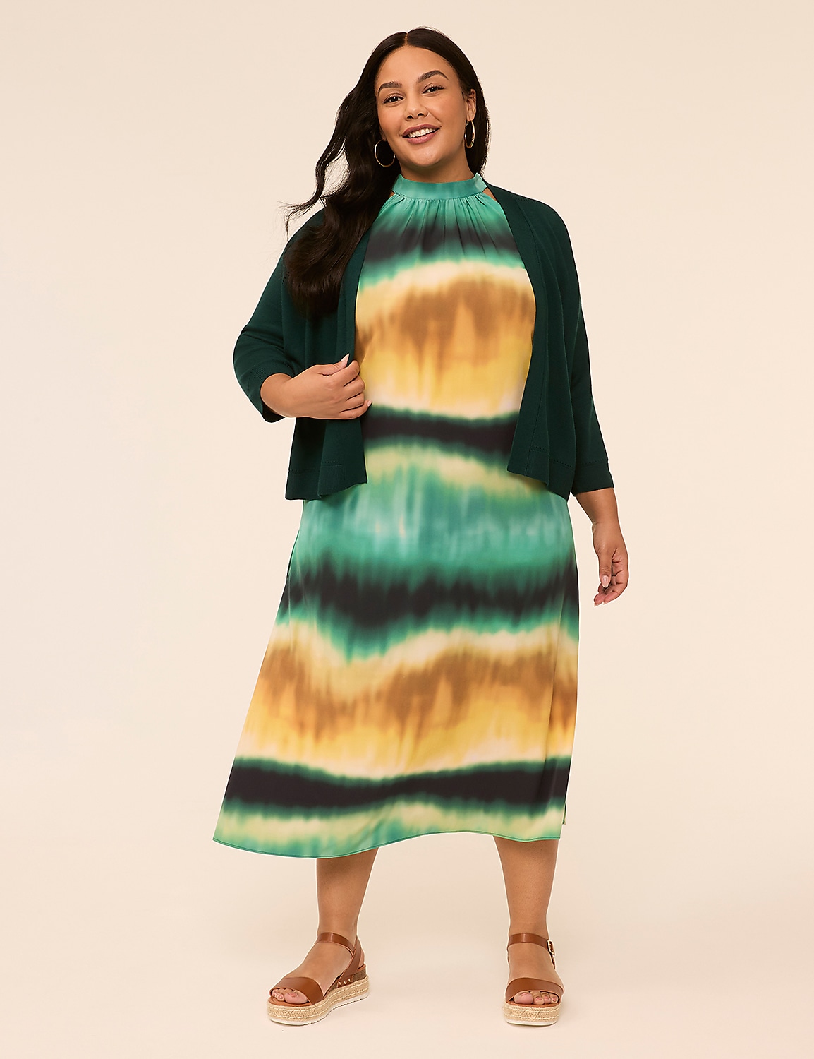 A smiling woman wearing a vibrant, multicolored dress stands against a plain, light-colored background. Product Image 3
