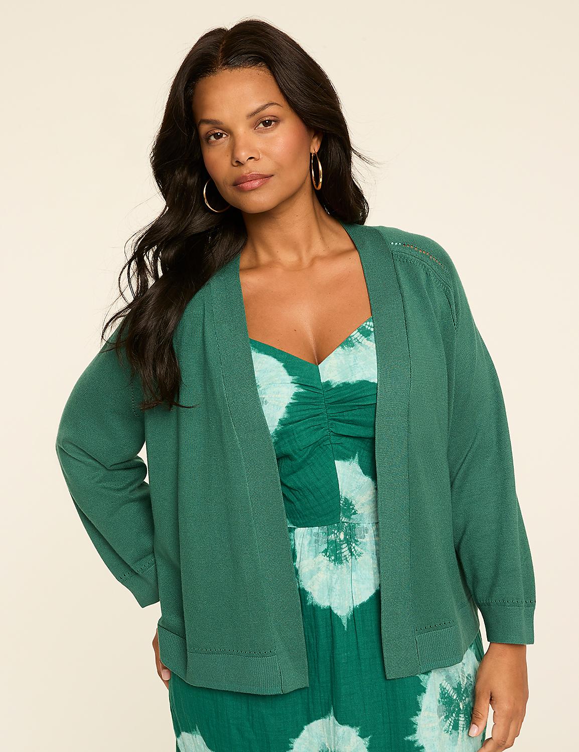 The image shows a woman with long dark hair wearing a green jacket and a patterned green dress, standing against a plain light-colored background. Product Image 3
