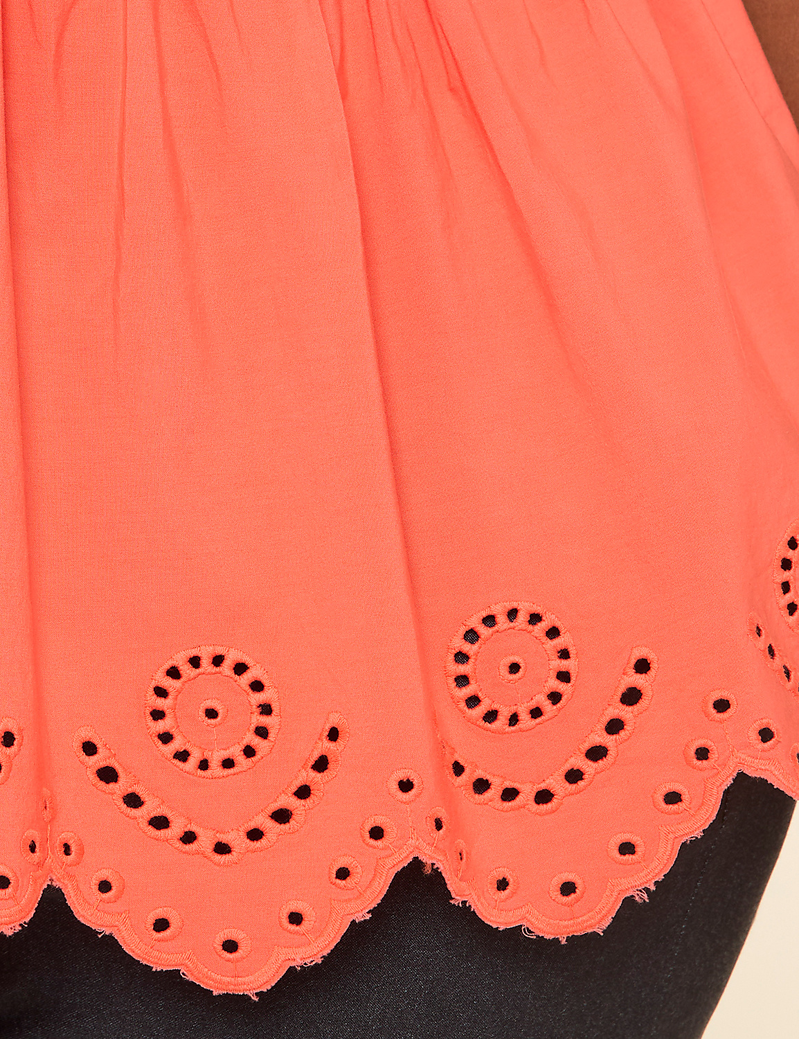 A vibrant, coral-colored fabric with a scalloped, embroidered edge against a dark background. Product Image 4
