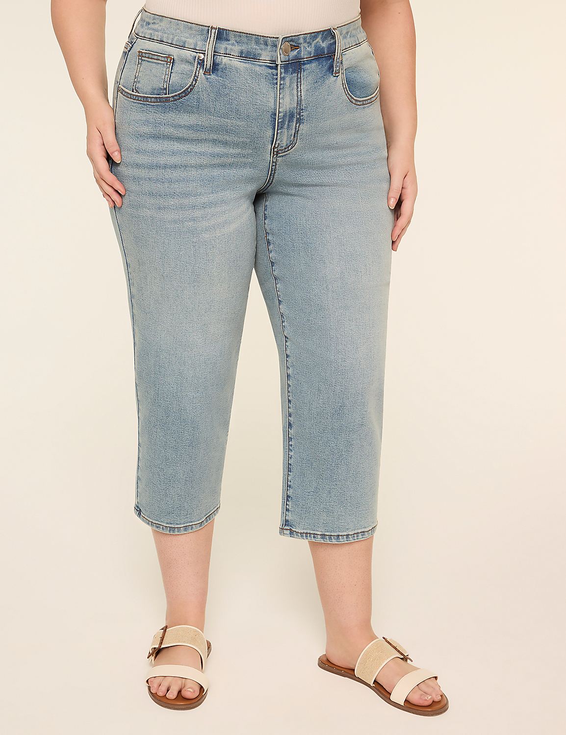 The image shows a pair of light-colored denim shorts or capri pants worn with a pair of beige sandals on a plain background. Product Image 1