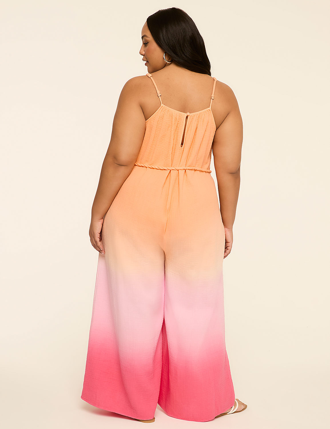A woman in a flowing, ombre jumpsuit stands against a plain, light-colored background. Product Image 2