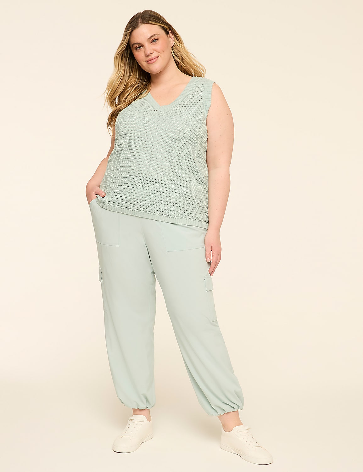 A woman in a light green knit vest and matching pants stands against a plain, light-colored background. Product Image 3