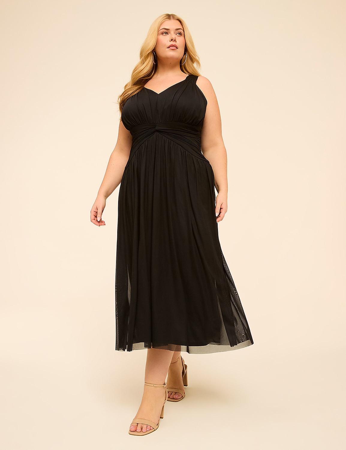 A plus-size woman in a black floor-length gown stands against a plain, light-colored background. Product Image 1