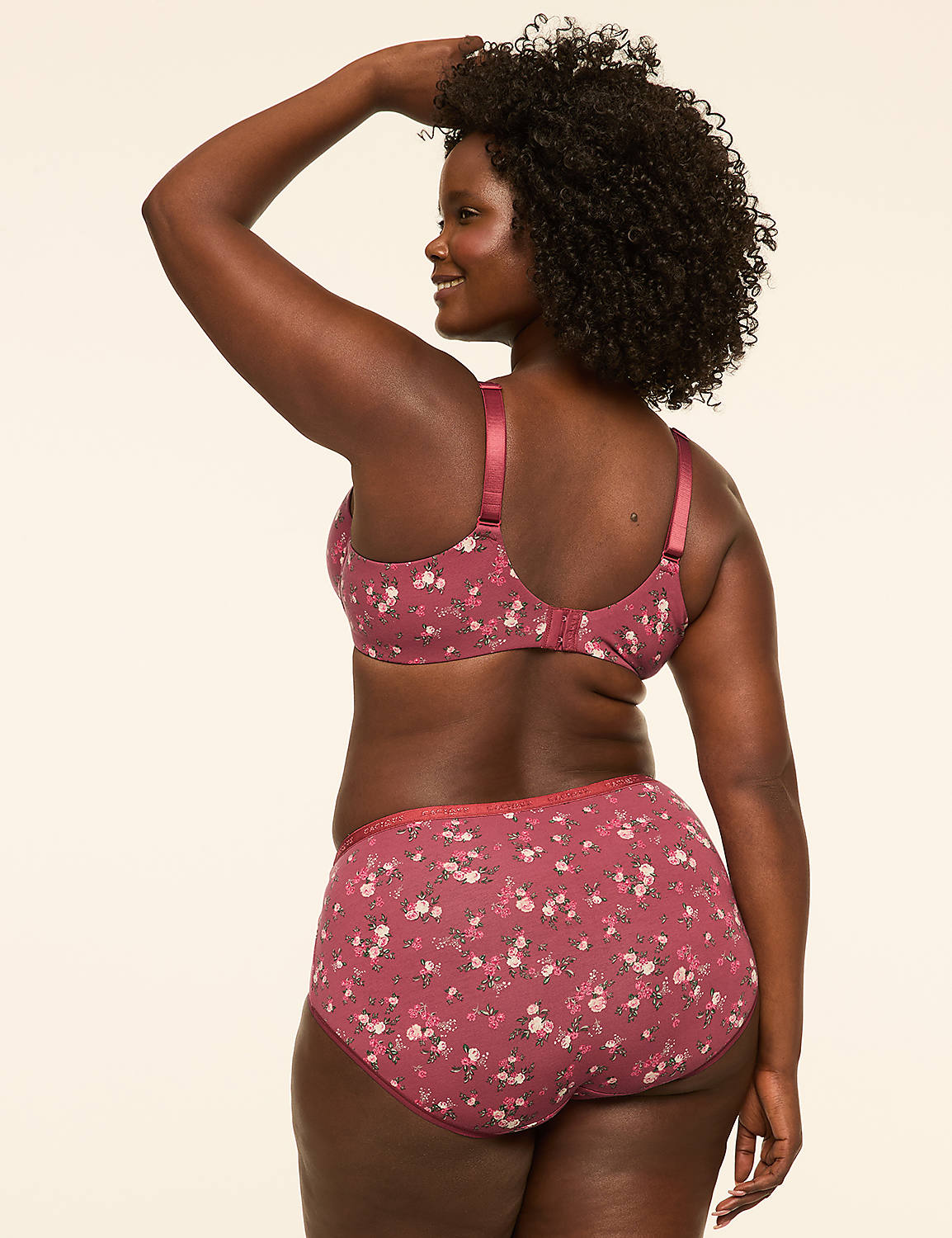 A woman in a floral bra and matching underwear poses with her arm raised against a plain, light-colored background. Product Image 2