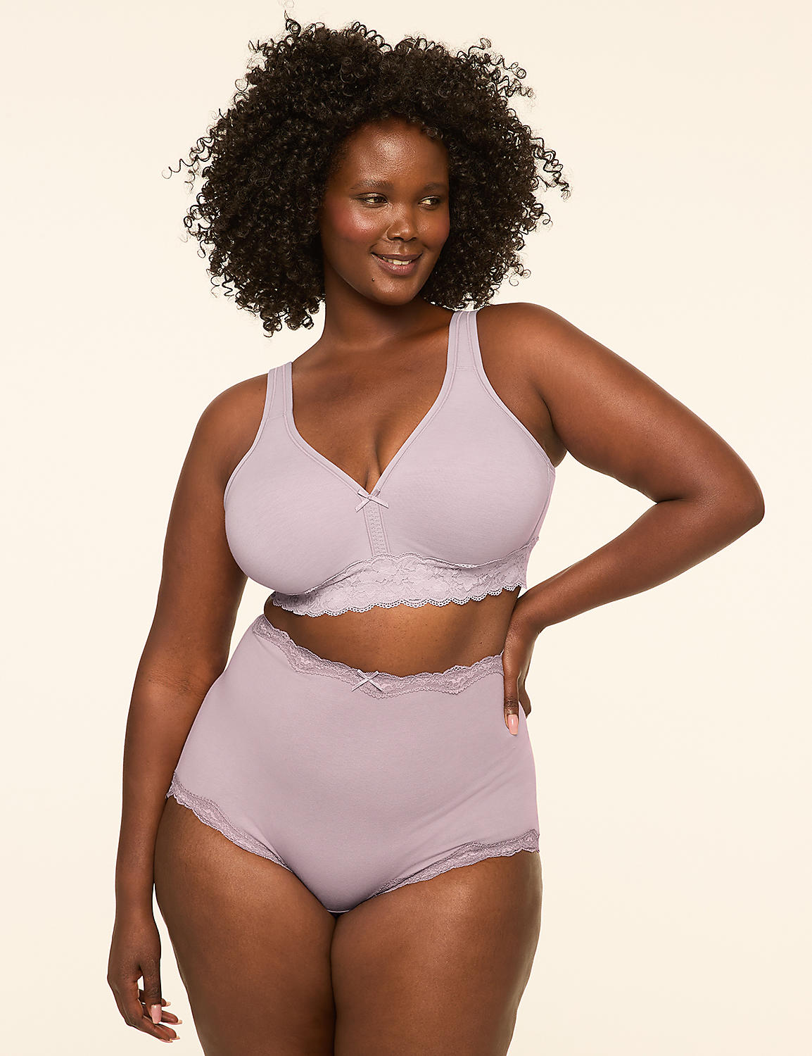 A plus-size woman with dark curly hair poses in a light purple bra and matching high-waisted underwear against a plain, light-colored background. Product Image 4