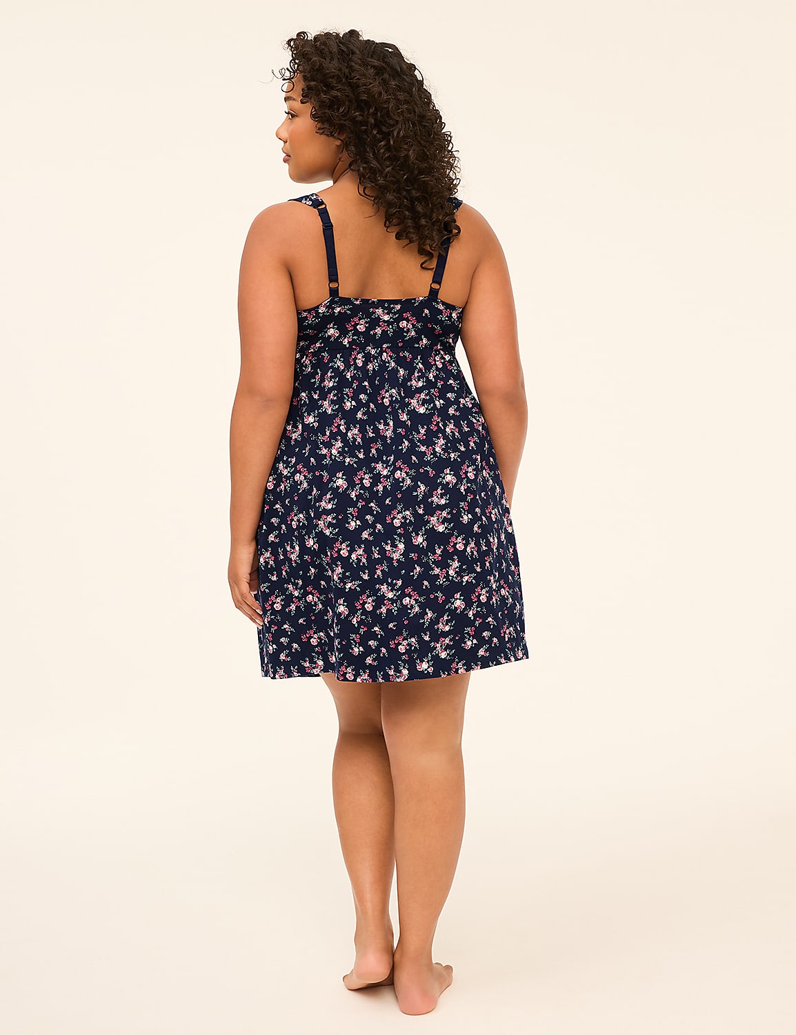 A woman in a floral dress stands against a plain, light-colored background. Product Image 2