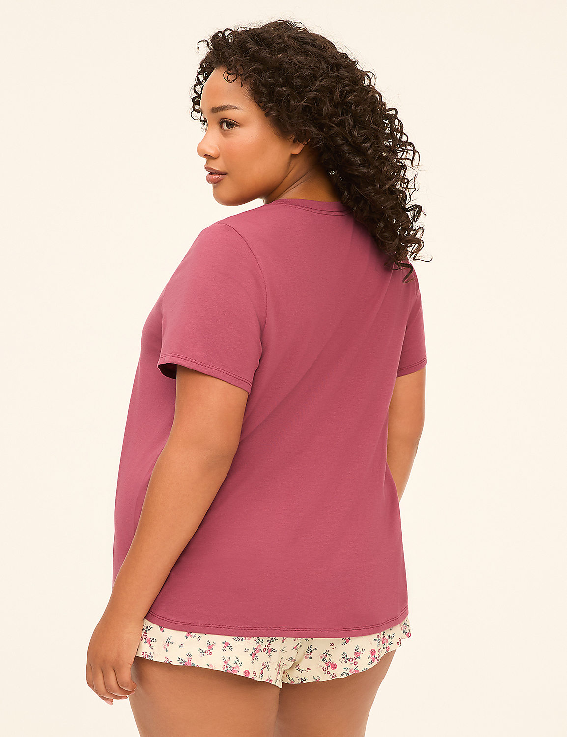 A woman in a mauve t-shirt and floral shorts stands against a plain, light-colored background. Product Image 2