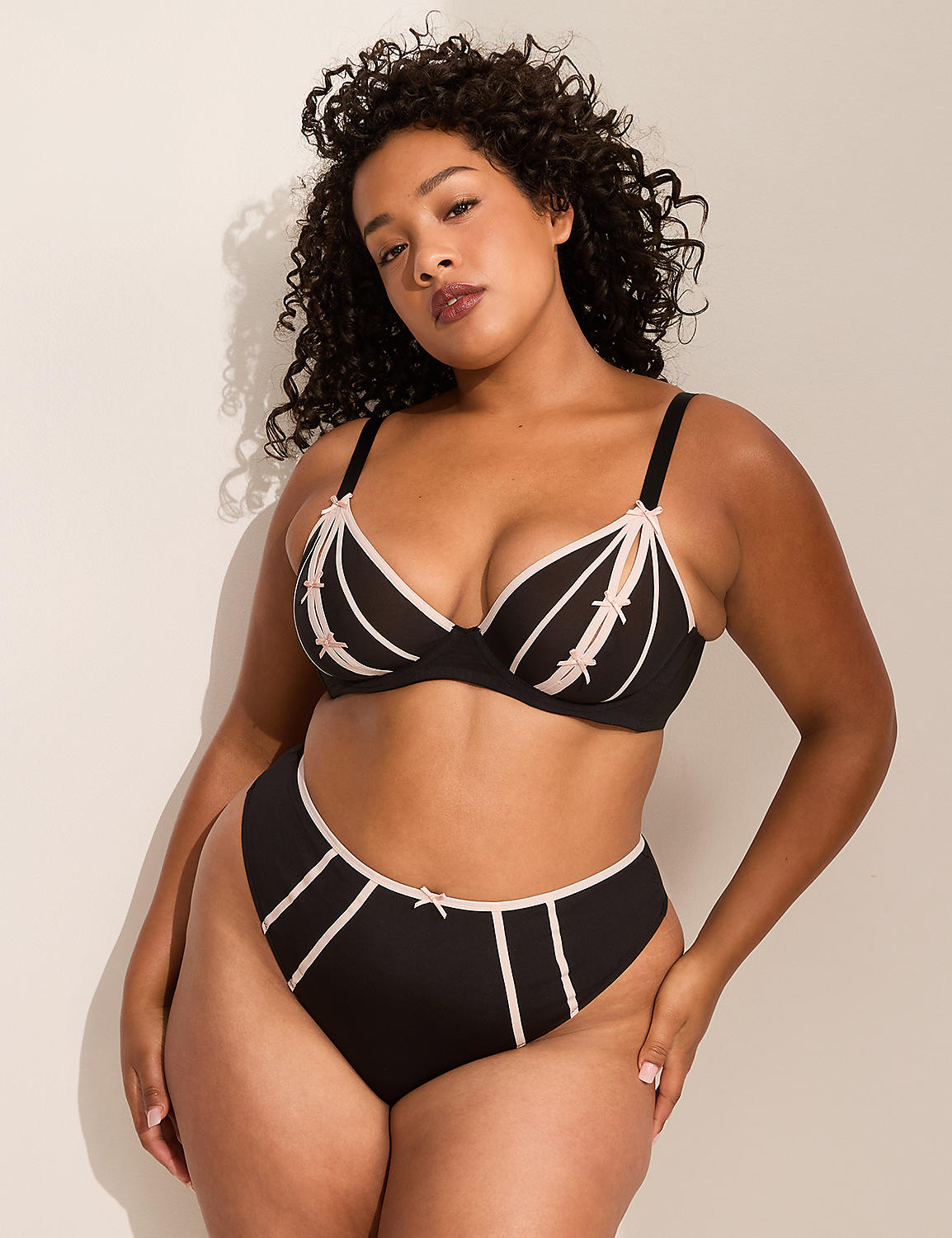 A woman in a black bra and high-waisted underwear stands against a plain white background. Product Image 4