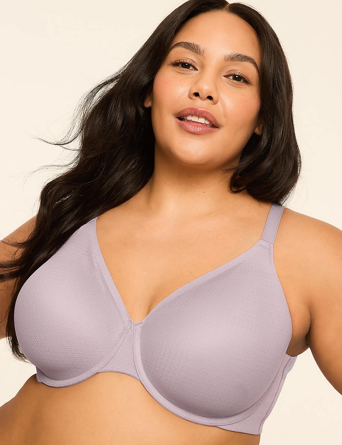 A woman with dark hair smiles gently in the foreground, wearing a light purple bra against a plain, light-colored background. Product Image 1