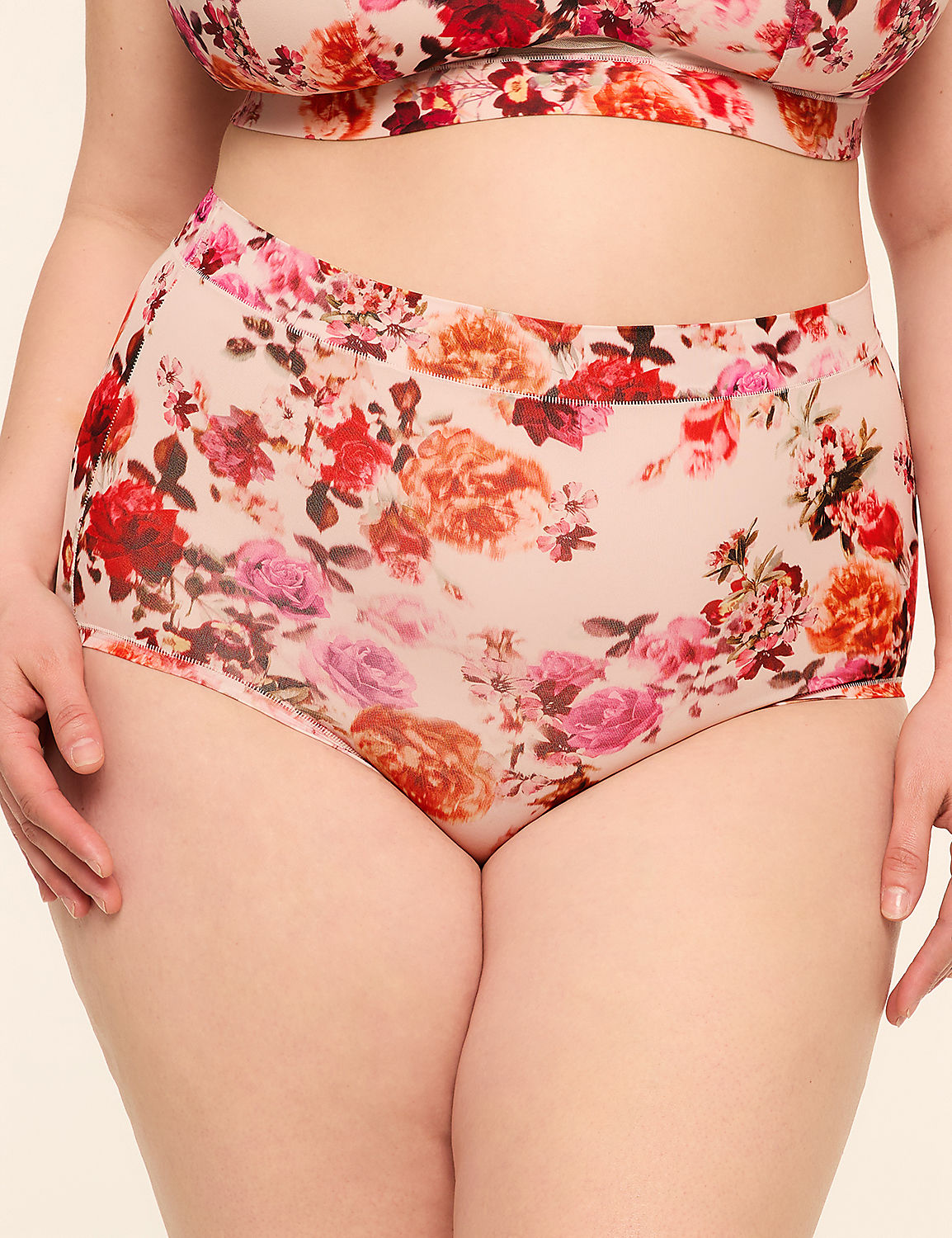 A person is wearing floral-patterned underwear and a matching bra against a plain background. Product Image 1
