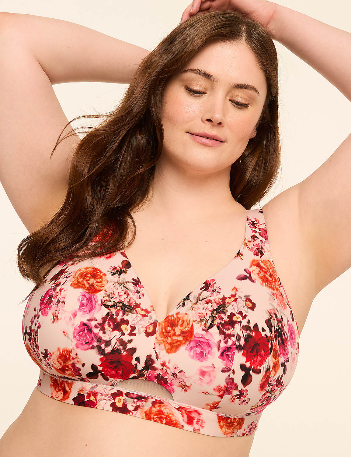 A woman with her arms raised behind her head wears a floral-patterned bra against a plain, light-colored background. Product Image 1