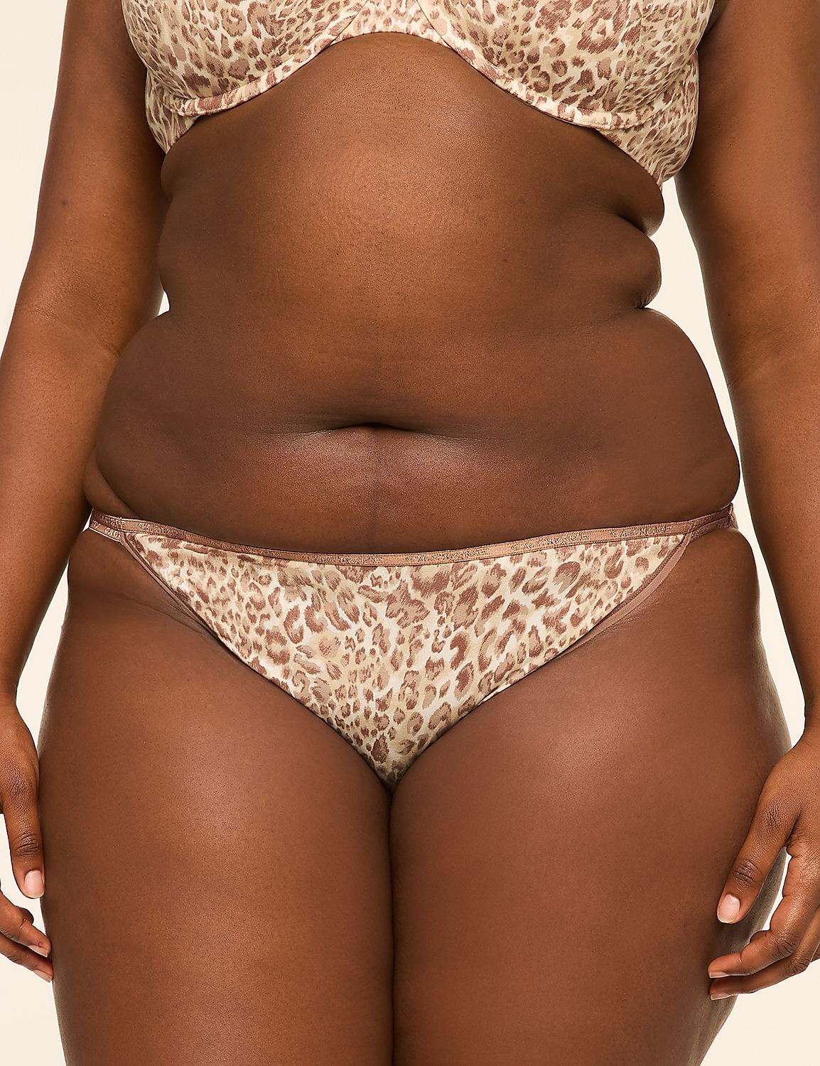 A person in leopard print lingerie stands against a plain, light-colored background. Product Image 1