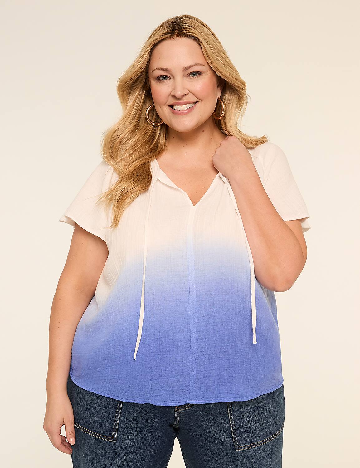 A blonde woman in a white top with lace detailing smiles as she looks to the left against a plain, light background. Product Image 1