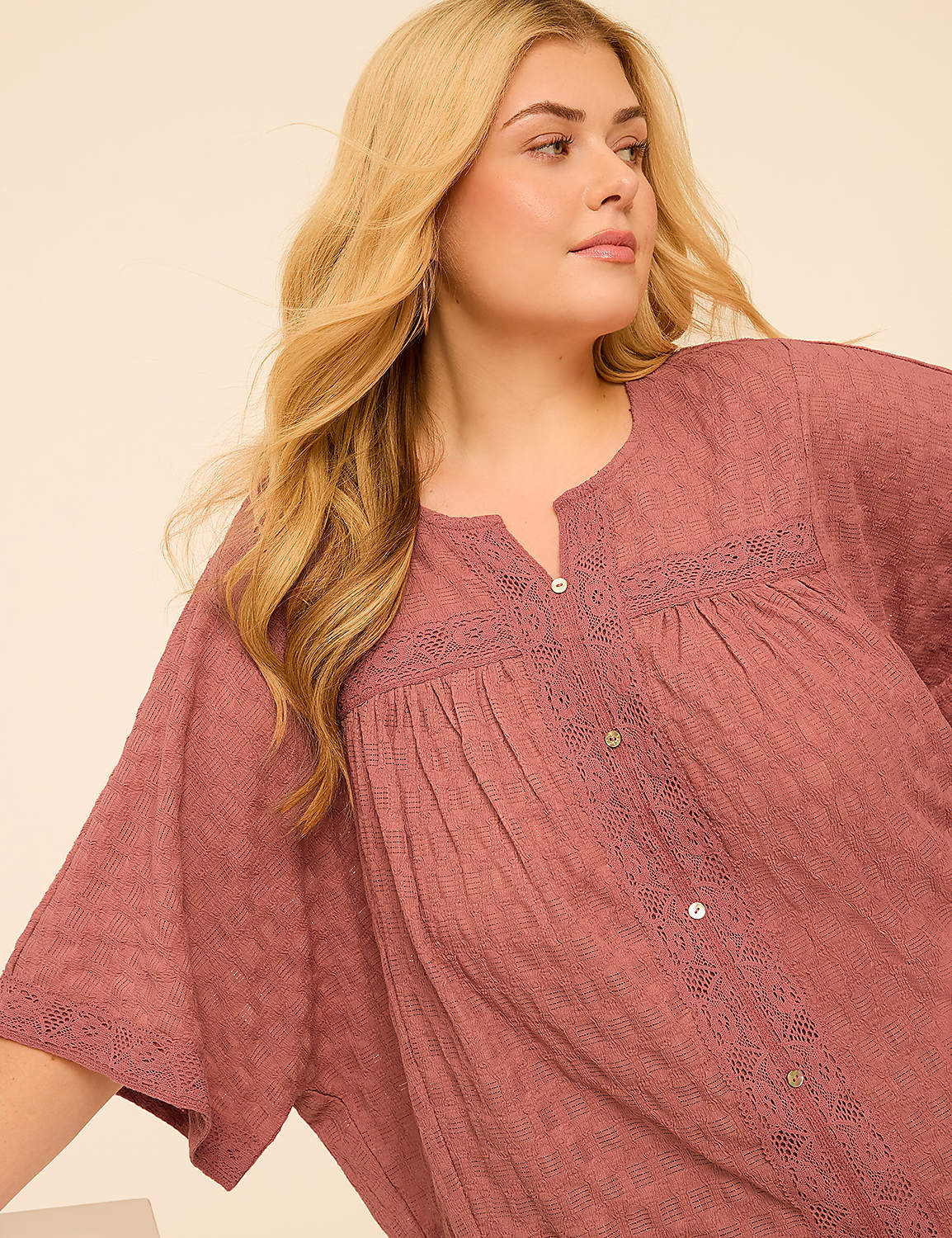 A woman with blonde hair and a pink blouse is in the foreground, with a plain, light-colored background. Product Image 4
